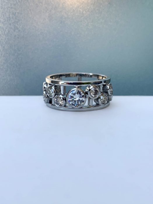 Platinum bespoke ring created by remodelling inherited diamond jewellery into a modern open-frame design.