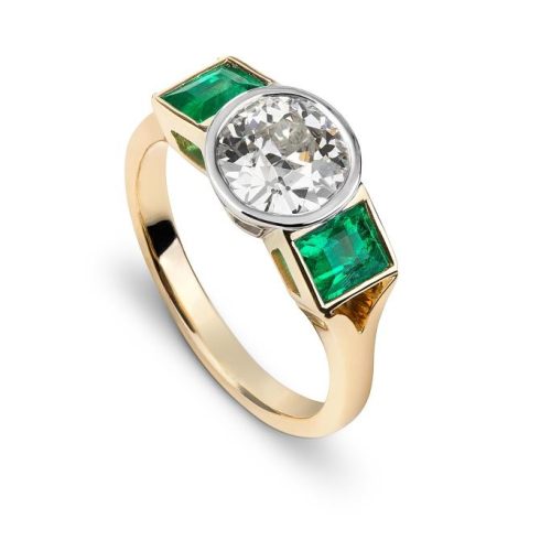 J1420 – Round Brilliant Cut Diamond with Side Emeralds Ring
