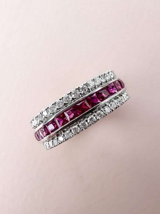 Diamond and ruby custom made wedding ring on pink background