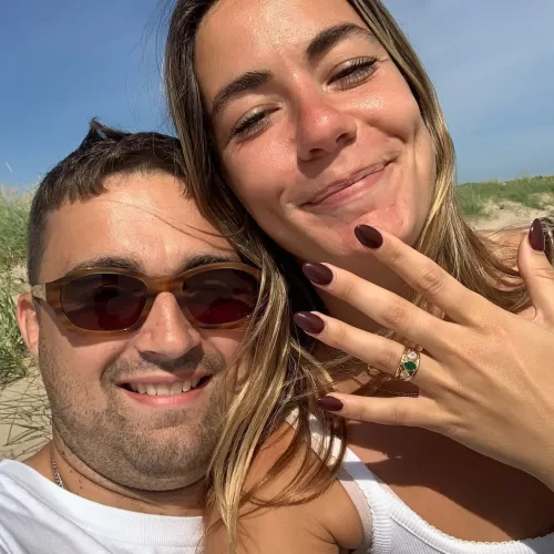 Happy couple wearing Emerald and Diamond Custom Three-Band Engagement Ring
