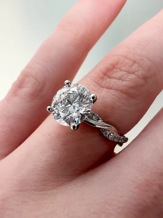 Custom Solitaire Engagement Ring close up on hand
