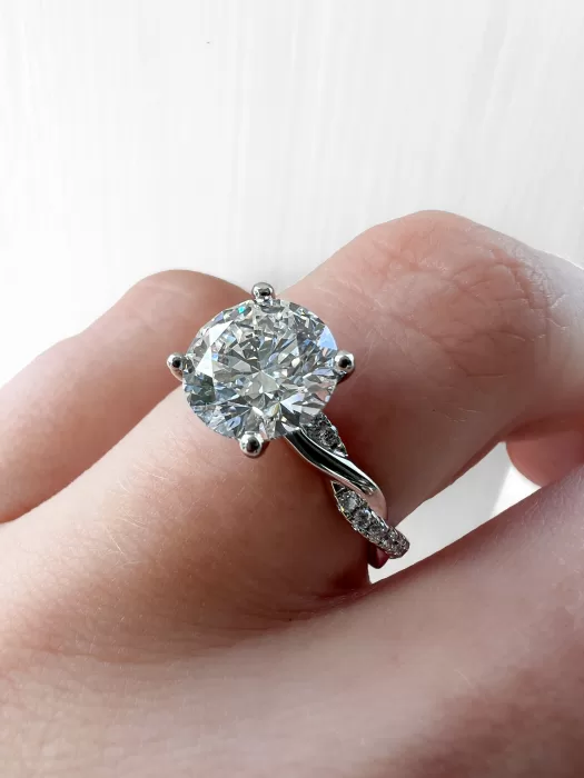 Custom Solitaire Engagement Ring close up on hand