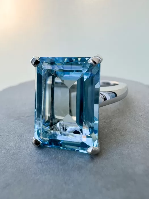 Octagon Cut Aquamarine Custom Solitaire Ring on table