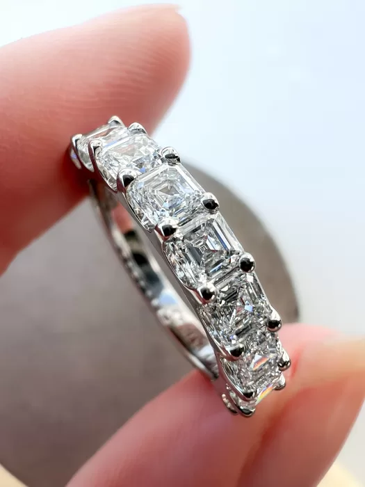 Asscher Cut Diamond Bespoke Wedding Ring between fingers