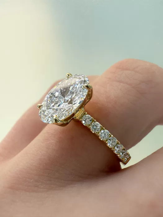 Bespoke oval diamond engagement ring on hang