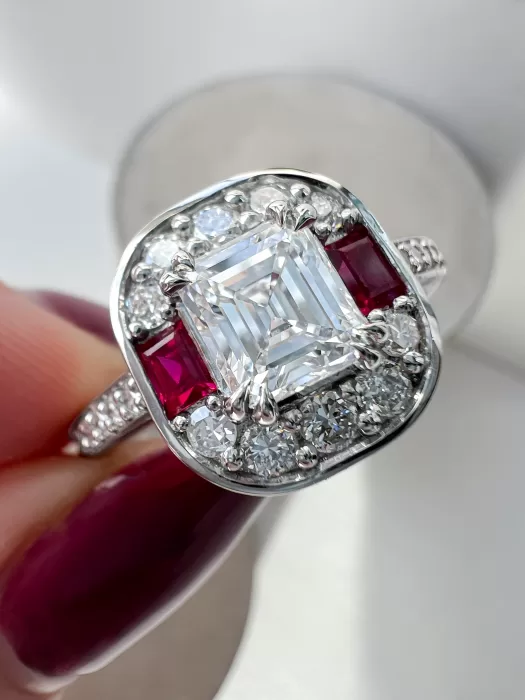 Custom Asscher Cut Diamond and Ruby Cluster Ring held between fingers