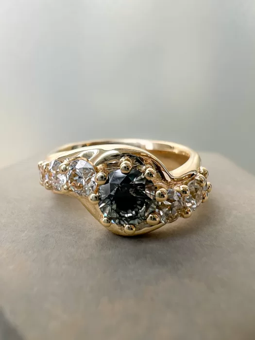 salt and pepper diamond bespoke engagement ring on concrete