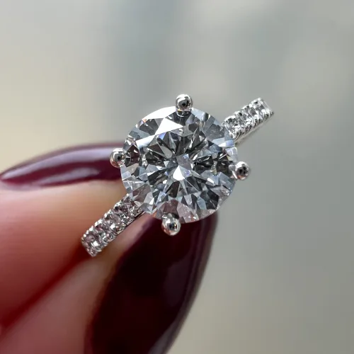 Platinum Solitaire Engagement Ring in fingers