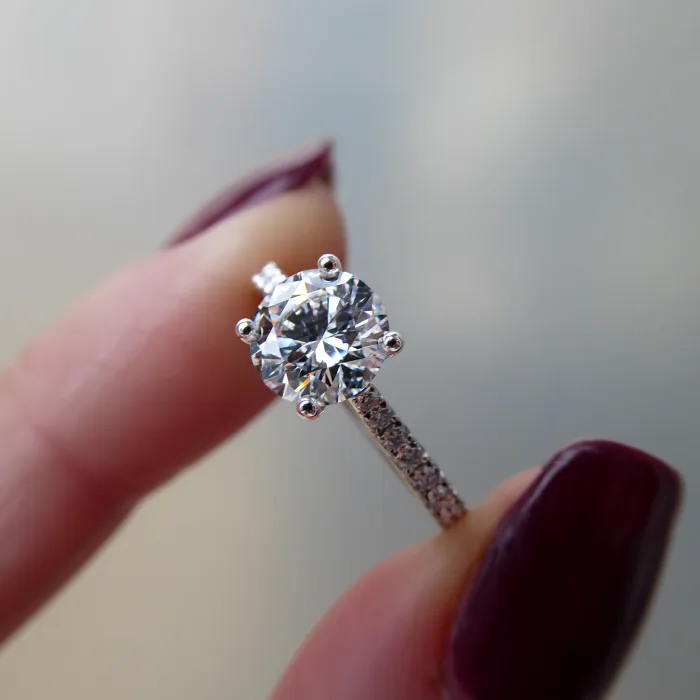 Platinum Solitaire Engagement Ring in fingers