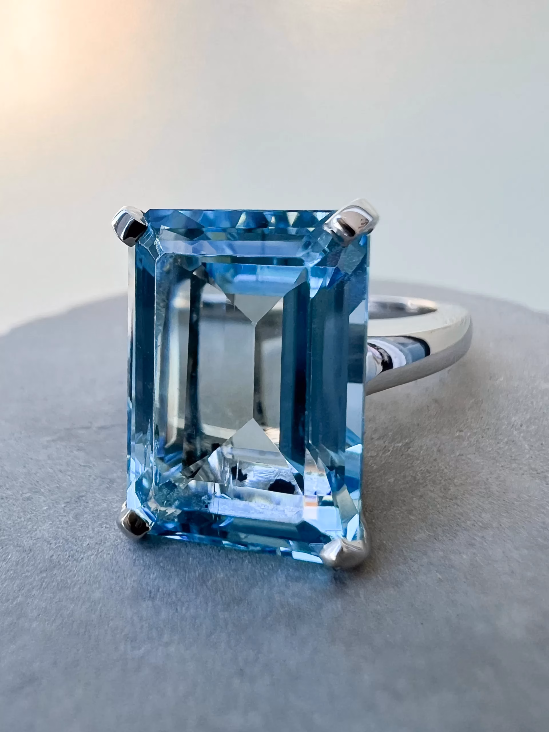 Octagon Cut Aquamarine Custom Solitaire Ring Octagon Cut Aquamarine Custom Solitaire Ring on table