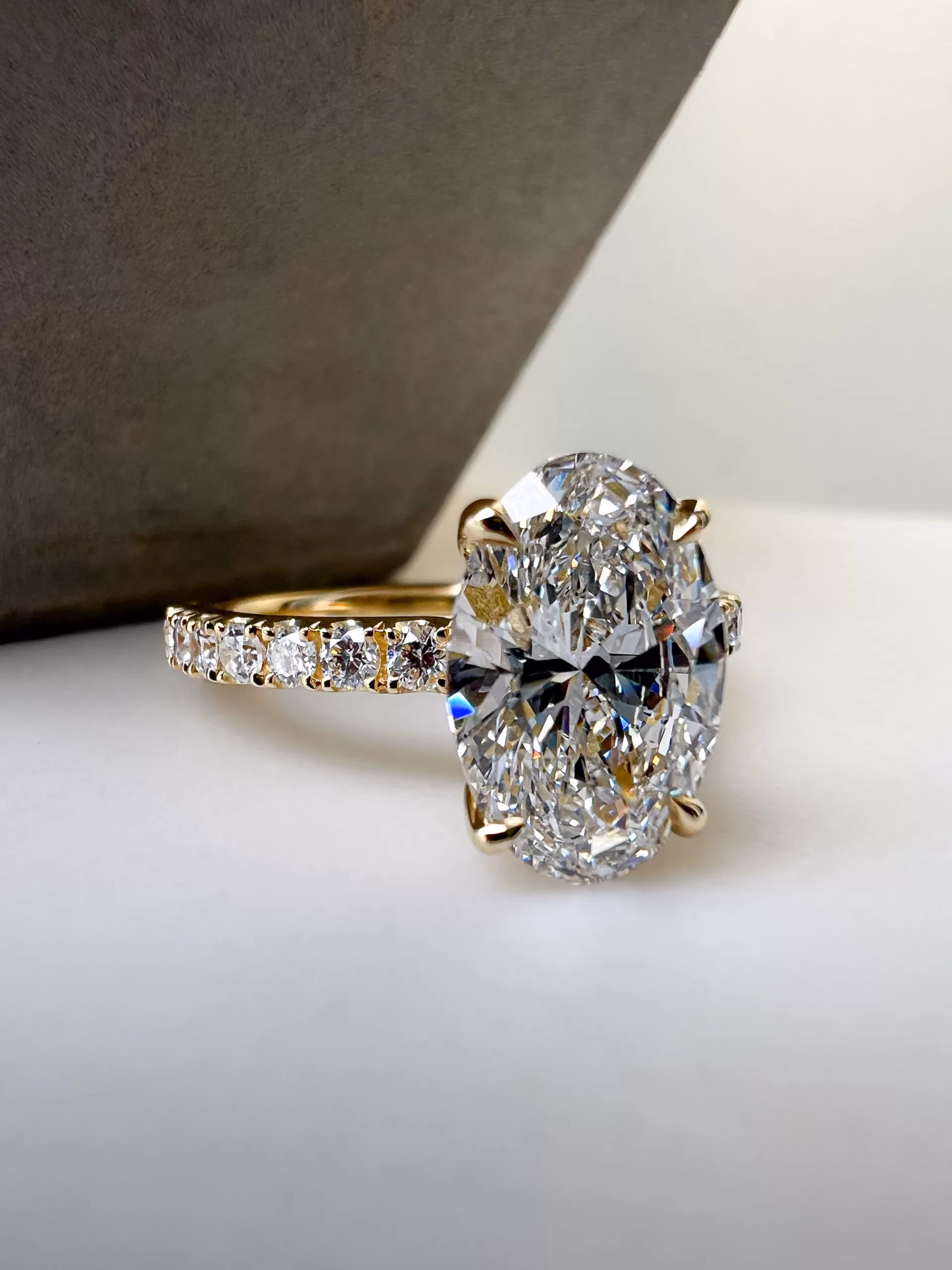 Bespoke oval diamond engagement ring Bespoke oval diamond engagement ring on table