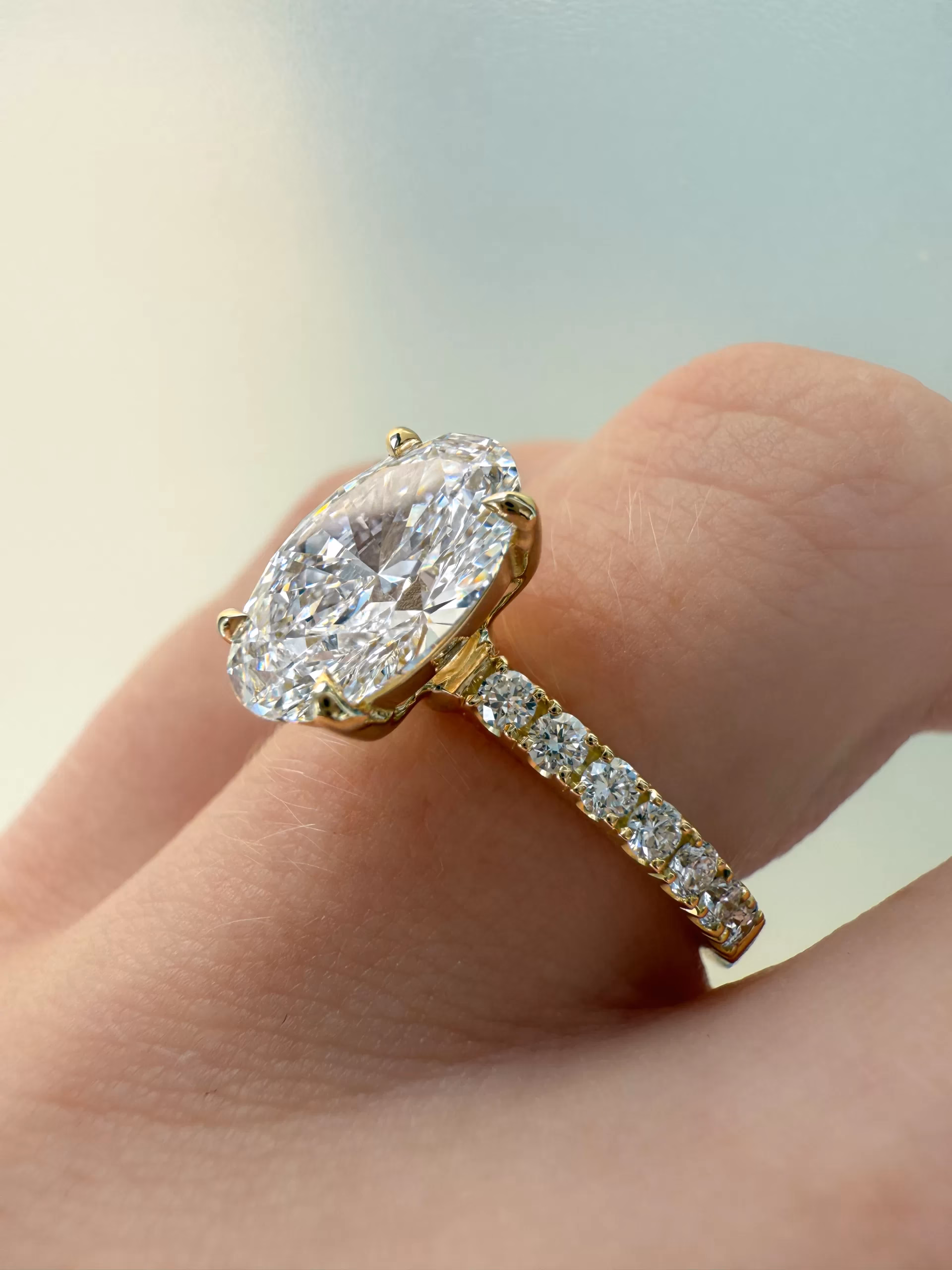 Bespoke oval diamond engagement ring on hang