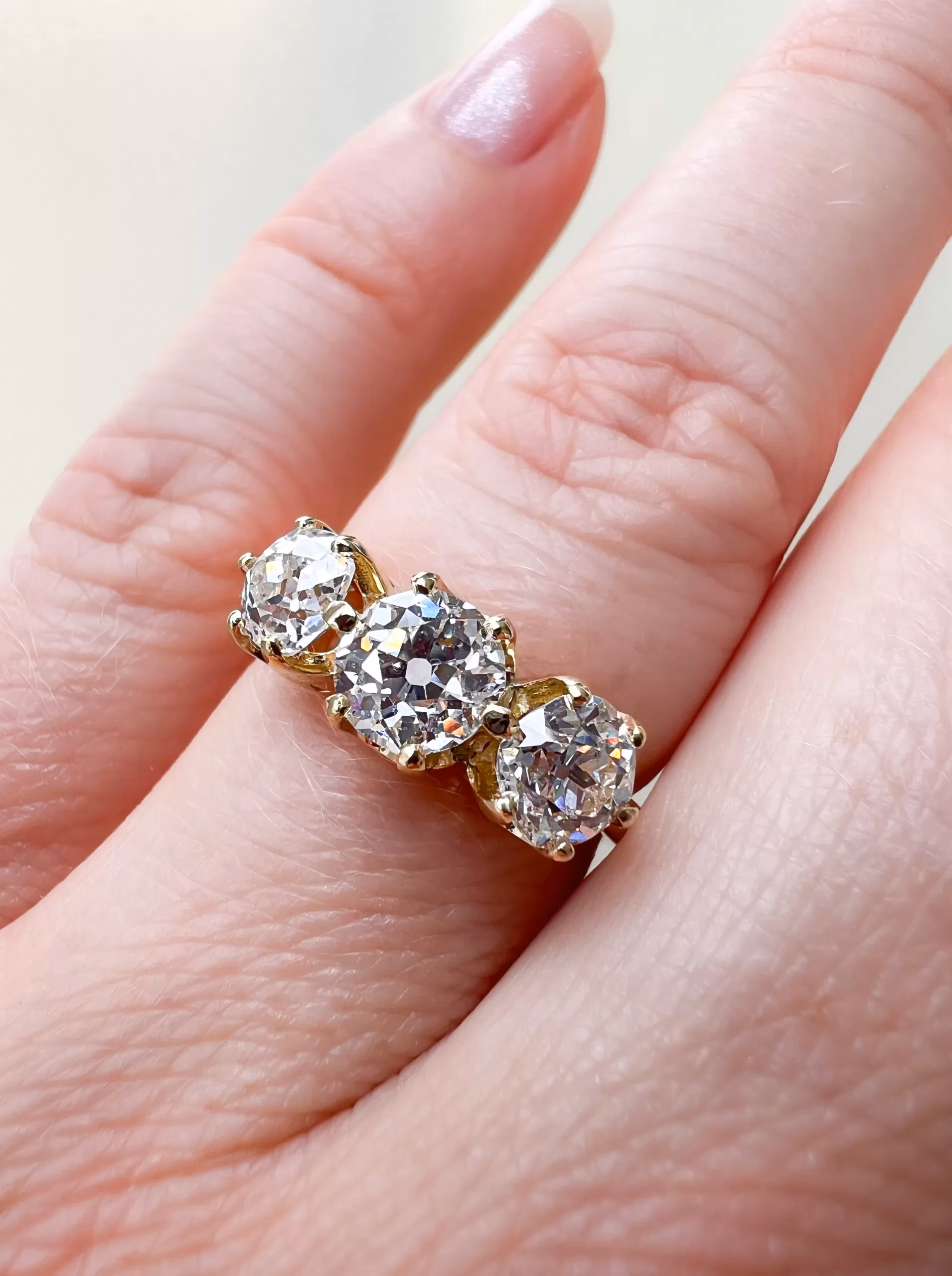 Custom Old Cut Diamond Three-Stone Ring on hand